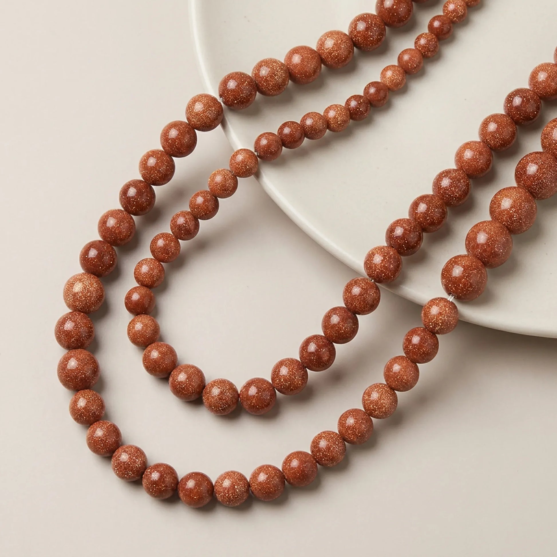 Round goldstone beads with smooth sparkling surface